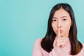 Woman with finger in front of mouth on lips Royalty Free Stock Photo