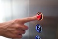 Woman finger presses a button in elevator closeup Royalty Free Stock Photo