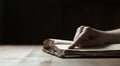 Woman finger presses on old bible book