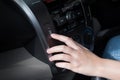 Woman finger pressing button defrost detail on a car`s dashboard