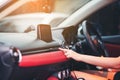 Woman finger pressing emergency button on car dashboard. Transportation Concept, The female hand presses the button to turn the Royalty Free Stock Photo