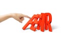 Woman finger pushing domino of red fear word falling