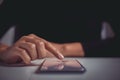 Woman finger signing contract on mobile phone screen. Concept of signing legally binding contracts through paperless remote