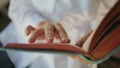 Woman fingers holding book running pages closeup. Adult reader enjoying hobby