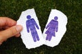 Woman fingers holding piece of paper with hand drawn man figure Royalty Free Stock Photo