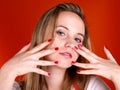 Woman with fingers over her face Royalty Free Stock Photo