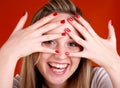 Woman with fingers over her face Royalty Free Stock Photo