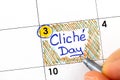 Woman fingers with pen writing reminder Cliche Day in calendar Royalty Free Stock Photo