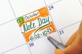 Woman fingers with pen writing reminder Mole Day in calendar Royalty Free Stock Photo
