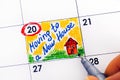 Woman fingers with pen writing reminder Moving to a New House in