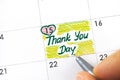Woman fingers with pen writing reminder Thank You Day in calendar Royalty Free Stock Photo