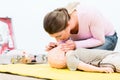 Woman in first aid course practicing revival of infant on baby d Royalty Free Stock Photo