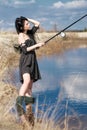 Woman fishes on the lake Royalty Free Stock Photo