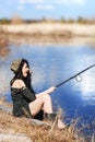 Woman fishes on the lake Royalty Free Stock Photo