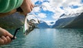 Woman fishing on Fishing rod spinning in Norway