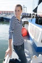 woman at fishing harbour wearing stripey top