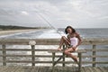 Woman fishing on the pier Royalty Free Stock Photo