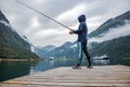 Woman fishing on Fishing rod spinning in Norway Royalty Free Stock Photo