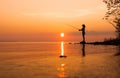 Woman fishing on Fishing rod spinning at sunset background Royalty Free Stock Photo