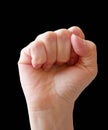 Woman fist isolated on black background. Raised fist as human hand up with protest, victory, strength, power. Counting, aggression