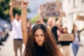 Woman, fist and portrait with protest crowd in street for planet, climate change or sustainable future. Girl, leadership Royalty Free Stock Photo