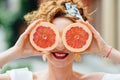 Woman fit girl holding two halfs of grapefruit Royalty Free Stock Photo