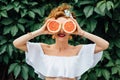 Woman fit girl holding two halfs of grapefruit Royalty Free Stock Photo