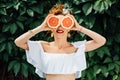 Woman fit girl holding two halfs of grapefruit Royalty Free Stock Photo