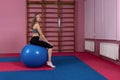 Woman on a fitness ball in a gym - Image Royalty Free Stock Photo