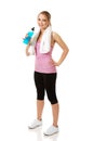 Woman in fitness clothes drinking isotonic drink.