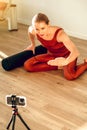 Woman fitness couch broadcasting her workout using mobile phone on tripod