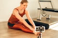 Woman fitness couch broadcasting her workout using mobile phone on tripod