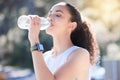 Woman, fitness and drinking water in nature for sustainability after workout, running or exercise. Fit, active and Royalty Free Stock Photo