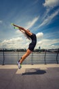 woman fitness instructor doing training summer day city promenade along river