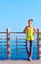 Woman in fitness outfit looking into distance at embankment Royalty Free Stock Photo