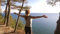 Woman fitness runner on top happy and celebrating success. the woman enjoys the view of the sea from the mountain, she Royalty Free Stock Photo