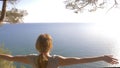 Woman fitness runner on top happy and celebrating success. the woman enjoys the view of the sea from the mountain, she Royalty Free Stock Photo