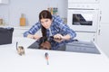 Woman fitting ceramic hob into kitchen unit Royalty Free Stock Photo