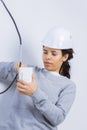 Woman fitting electrical outlet in bathroom