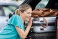 woman fitting luggage in carboot Royalty Free Stock Photo