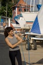 Woman Fixing Sail by Tying Knot in Rope - Vertical
