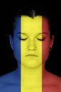 Woman with the flag of Rumania painted on her face.