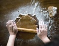 Woman flattening gingerbread cookie dough Royalty Free Stock Photo