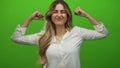 Woman flexes arms in studio; confidence strength Royalty Free Stock Photo
