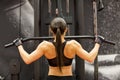 Woman flexing muscles on cable machine in gym Royalty Free Stock Photo