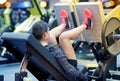 Woman flexing muscles on leg press machine in gym Royalty Free Stock Photo