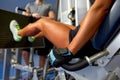 Woman flexing muscles on leg press machine in gym Royalty Free Stock Photo