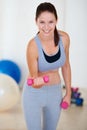 Woman, flexing or portrait with dumbbells in gym, health glow or fitness for weight loss with exercise. Young person Royalty Free Stock Photo