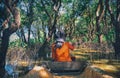 A woman floating on a boat in the village built on the Tonle Sap lake Royalty Free Stock Photo