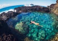 Woman floating in natural pool